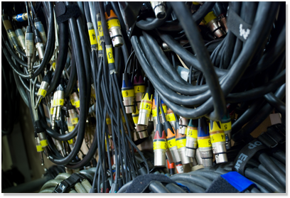 A photo of wrapped and labled cords on a warehouse shelf.